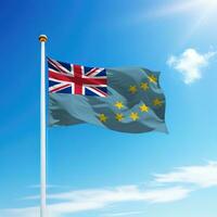 Waving flag of Tuvalu on flagpole with sky background. photo