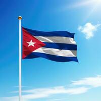 Waving flag of Cuba on flagpole with sky background. photo