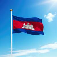 Waving flag of Cambodia on flagpole with sky background. photo