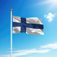 Waving flag of Finland on flagpole with sky background. photo