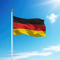 Waving flag of Germany on flagpole with sky background. photo