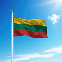 Waving flag of Lithuania on flagpole with sky background. photo