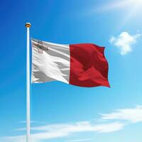 Waving flag of Malta on flagpole with sky background. photo