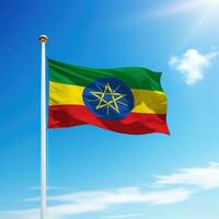Waving flag of Ethiopia on flagpole with sky background. photo