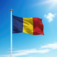 Waving flag of Romania on flagpole with sky background. photo