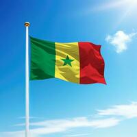 Waving flag of Senegal on flagpole with sky background. photo