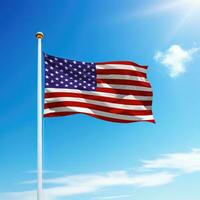 Waving flag of United States on flagpole with sky background. photo