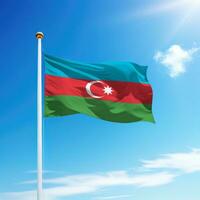 Waving flag of Azerbaijan on flagpole with sky background. photo