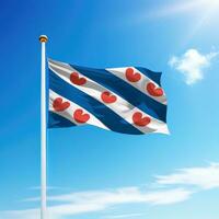 Waving flag of Friesland is a state of Netherlands on flagpole photo