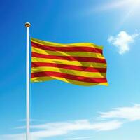 Waving flag of Catalonia  is a community of Spain on flagpole photo