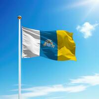 Waving flag of Canary Islands is a community of Spain on flagpole photo