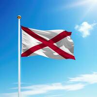 Waving flag of Alabama is a state of United States on flagpole photo