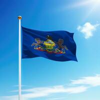 Waving flag of Pennsylvania is a state of United States on flagpole photo