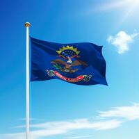 Waving flag of North Dakota is a state of United States on flagpole photo