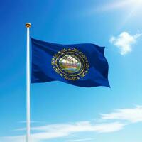 Waving flag of New Hampshire is a state of United States on flagpole photo