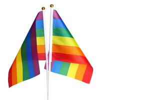 Rainbow flag on white background. It is a symbol of lesbian, gay, bisexual, and transgender pride and LGBT social movements. Also known as the gay pride flag or LGBT. photo