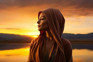 A reflective cancer patient gazing at a sunset isolated on a melancholic gradient background photo