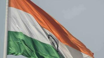 India flag flying high at Connaught Place with pride in blue sky, India flag fluttering, Indian Flag on Independence Day and Republic Day of India, tilt up shot, Waving Indian flag, Har Ghar Tiranga video