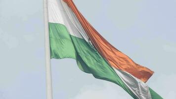 India flag flying high at Connaught Place with pride in blue sky, India flag fluttering, Indian Flag on Independence Day and Republic Day of India, tilt up shot, Waving Indian flag, Har Ghar Tiranga video