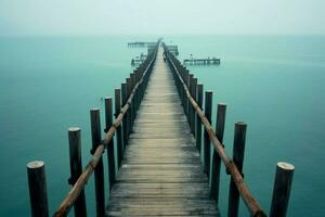 A long pier stretching far into the sea photo