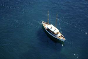 A private yacht bobbing in the calm water photo