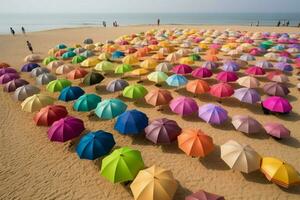 A rainbow of umbrellas dotting the sand photo