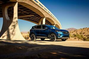 a blue kia sportage is parked under a bridge in the photo