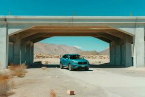 a blue kia sportage is parked under a bridge in the photo