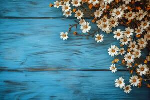 a blue wooden background with flowers on it photo