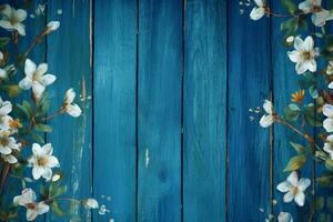 a blue wooden background with flowers on it photo