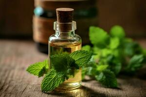 a bottle of essential oil next to a sprig of mint photo