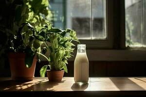 a bottle of milk sits on a table next to a plant photo