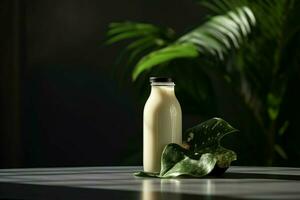 a bottle of milk with a black cap sits on a table photo