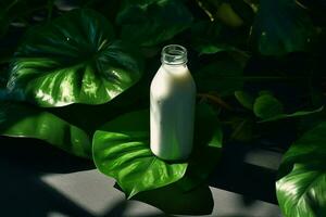 a bottle of milk with a black cap sits on a table photo