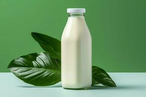 a bottle of milk with a green leaf next to it photo