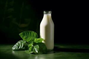 a bottle of milk with a green leaf next to it photo