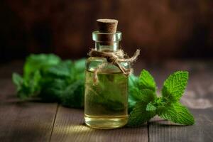 a bottle of mint essential oil next to a sprig of photo