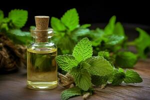 a bottle of mint essential oil next to a sprig of photo