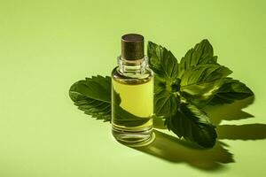 a bottle of mint essential oil with a green leaf photo