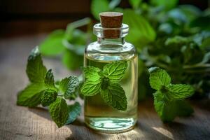 a bottle of mint essential oil next to a sprig of photo