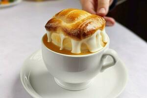 a cup is filled with a french pastry white backgrou photo