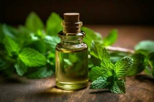 a small bottle of mint essential oil next to a pi photo