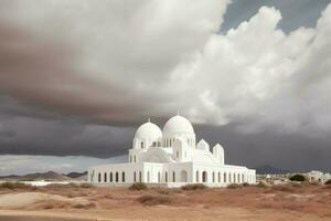 a white mosque with a large cloud in the backgrou photo