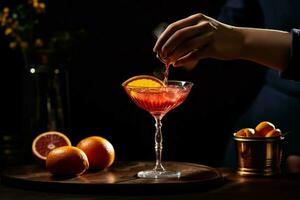 a woman is pouring a red cocktail into a glass wi photo
