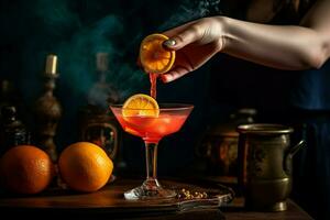 a woman is pouring a red cocktail into a glass wi photo