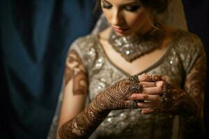 elegant bride henna adorning hand and beauty photo