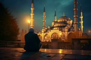Orando a el azul mezquita a oscuridad foto
