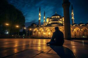 praying at the blue mosque at dusk photo