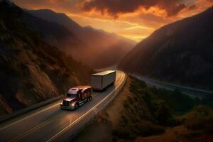 truck driving through mountain pass at sunset photo