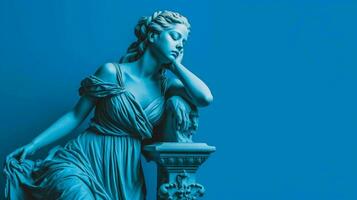 a blue statue of a girl with a blue background photo